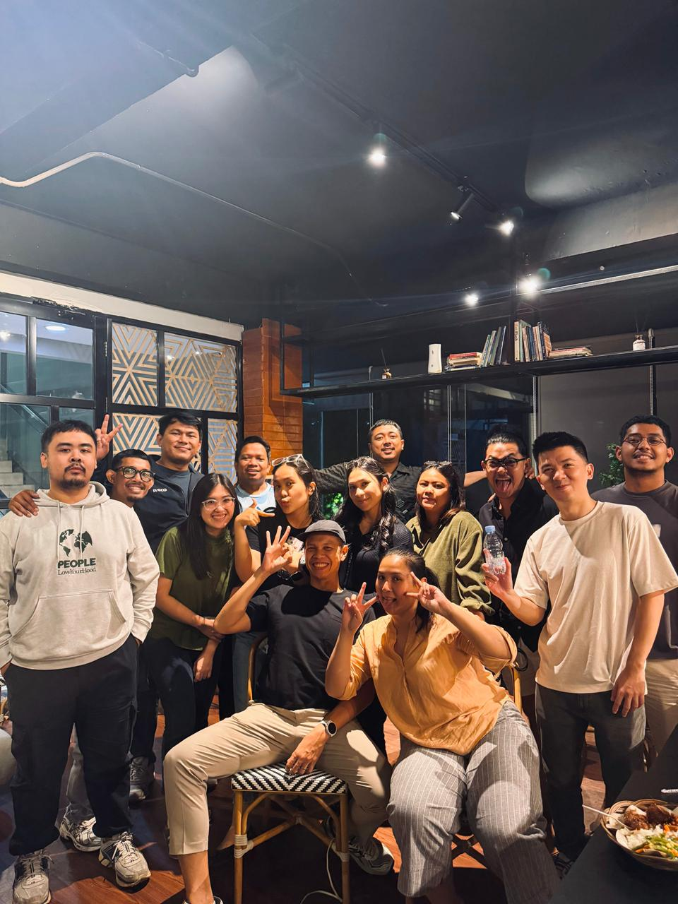 A smiling group gathering together inside F! Coffee