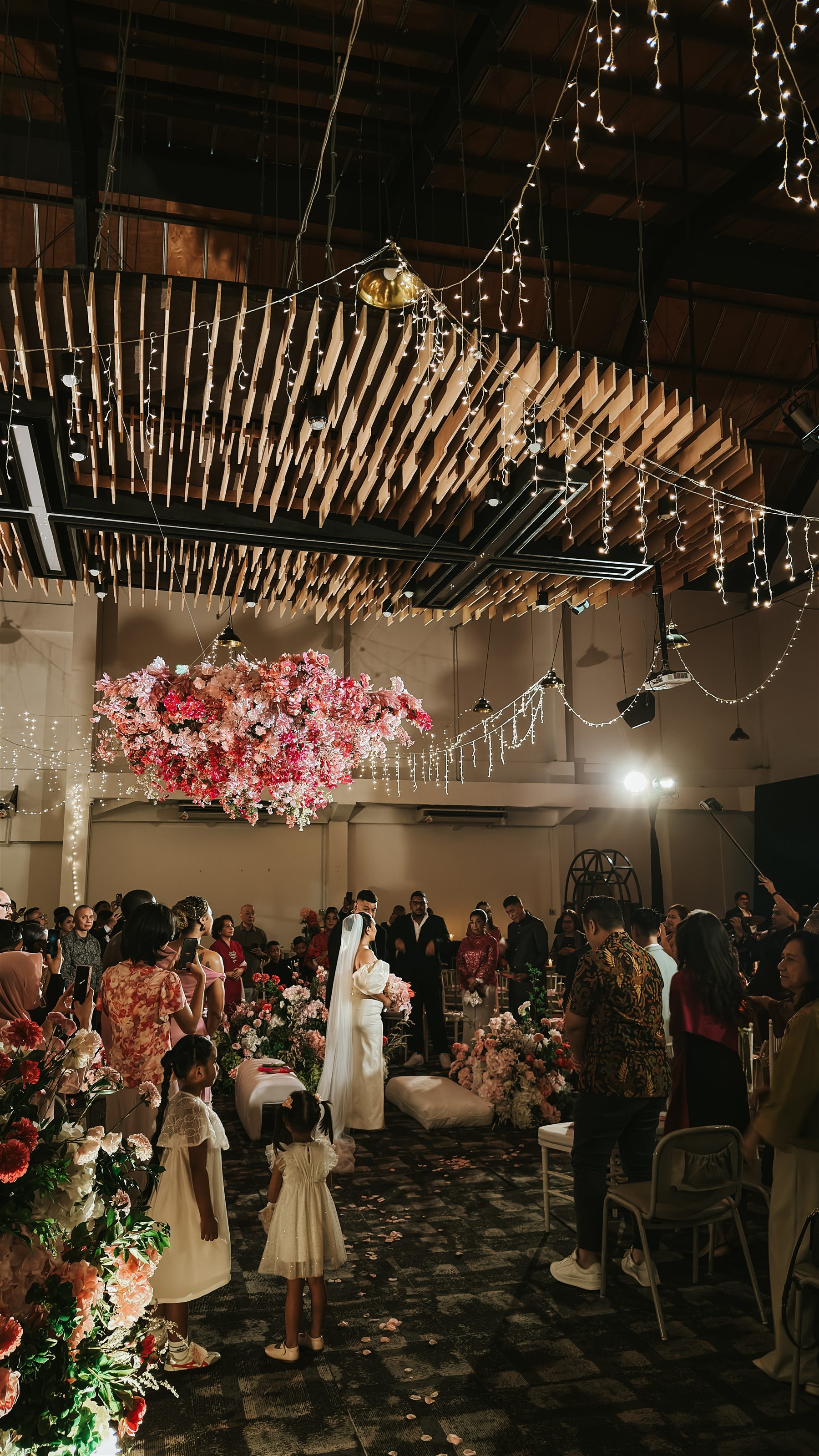Wedding celebration with the bride, guests, floral styling and hanging lights at Heart Space 2.0